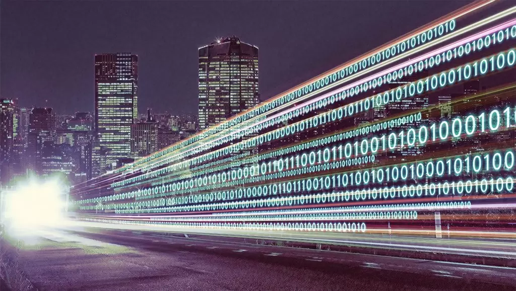 Digital data streams represented by binary code over a cityscape at night, symbolizing the digital transformation in asset management driven by automation, AI, and data analytics.