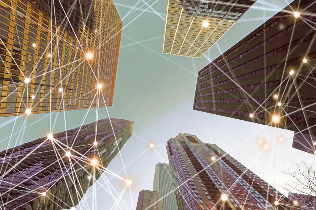 Upward view of interconnected skyscrapers with glowing network lines, symbolizing global connections, modern strategies, and innovation